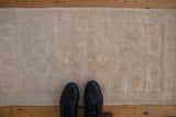Faded texture and subtle tone-on-tone pattern on a distressed Oushak rug.