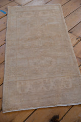 Vintage distressed Turkish Oushak mat runner, beige tone-on-tone medallion and subtle niches.
