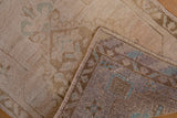 Distressed Oushak rug pile, folded revealing hand knotting and original selvage with pale green.