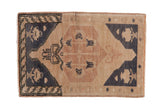 Vintage distressed Oushak rug mat with a geometric medallion in charcoal, dusty sandalwood, and cream tones.