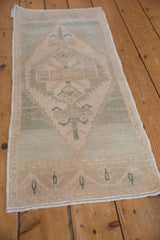 Distressed vintage Turkish Oushak runner, lightning serrated medallion on soft cream and seafoam.