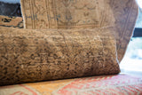 Antique Persian pillow fragment surface, displaying worn patterns and visible knot heads.