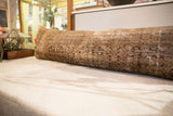 Extra long antique Persian lumbar pillow, faded patterns in beige, brown, and charcoal.