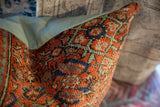 Vintage Persian rug fragment pillow with rust coral, blue, seafoam geometric texture.