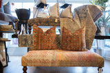 Vintage Persian rug fragment throw pillow displaying intricate rust coral, blue, and ivory patterns.