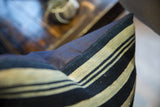 Indigo striped African textile detail meeting navy linen blend pillow backing.