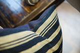Indigo and cream stripes with aged texture on vintage African textile pillow.