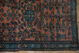 Intricate floral blossoms and detailed indigo border work of a fine Farahan Sarouk collector rug.