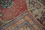 A collector Senneh's folded corner contrasts the muted pile with the vibrant colors of the reverse weave.