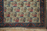 Detail of a pictorial Persian rug showing female figures, the indigo and red floral border, and fringe.