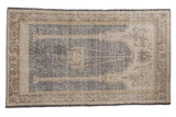 A distressed vintage Sparta rug with a double column prayer motif and mehrab in oxidized silver and ivory tones.