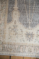 Close-up on the distressed low pile of a Sparta rug showing the lantern motif detail.