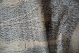 Exposed foundation and knot heads in ivory and silver on a distressed Sparta rug.