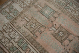 Textured distressed Melas rug, dusty rose, pale bronze, sea foam green geometric pattern.