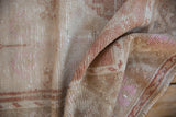 Detail of the even wear to the knot heads and side cord on a distressed Oushak rug.
