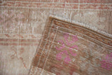 Reverse view of a vintage Oushak rug showing its hand-knotted foundation and secured selvage.