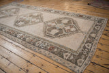 Distressed Oushak runner medallion and geometric tree-of-life border in ivory, silver, and blue.