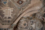 Textured pile of distressed vintage Oushak rug in soft ivory and pale blue hues.