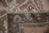 Distressed Oushak runner with hand-knotted pile, fringe, and woven foundation.