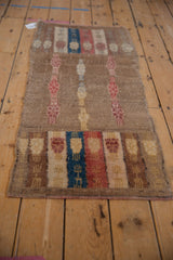 Distressed vintage Oushak runner showing worn camel pile and the original side cord selvage.