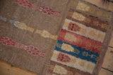 Vintage Distressed Oushak runner showing faded camel, red, and blue patterns with worn texture.