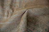 Worn texture of distressed Oushak rug, revealing exposed knot heads and subtle green designs.