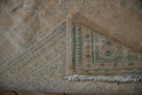 Vintage distressed Oushak rug showing worn pile and hand-knotted foundation.
