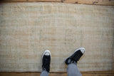 Textured distressed Oushak runner showing exposed foundation and muted tones.