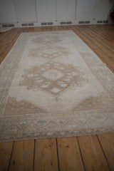 Textural detail of vintage Oushak runner with faded geometric motifs and mostly even wear.