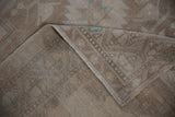Distressed Oushak rug with even wear, showing faded motifs and woven foundation.