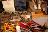 Bundled pair of cream beeswax taper candles with a gray Greentree Home ribbon.