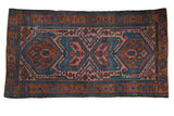 Vintage Persian Mehreban rug, geometric medallions in rust, sky blue, and pale raspberry.