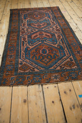 Vintage Mehreban rug detail of sky blue, madder root, and blush geometric pattern with side cord.