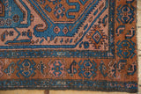 Vintage Mehreban rug corner showing madder root border, sky blue geometric patterns, and secured selvage.