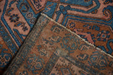 Vintage Mehreban rug, folded corner revealing blue, rust, pink patterns and woven foundation.