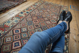 Antique Caucasian runner with geometric diamond lattice and crab guls in rich colors.