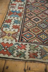 Nuanced geometric crab gul border and diamond lattice field on antique Caucasian runner.