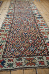 Close-up of antique Caucasian runner's multi-hued diamond lattice and stepped floral motifs.
