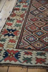 Antique Caucasian runner's cream border with crab guls and geometric diamond lattice field.