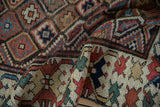 Antique Caucasian runner's madder red geometric field and unique crab gul border details.