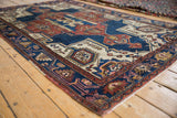Vintage Hamadan rug detail, showing geometric floral motif in navy blue, rust, and ivory.