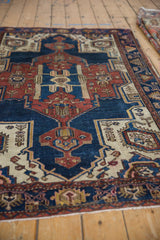 Vintage Hamadan rug's navy blue, rust, and ivory geometric floral pattern detail.