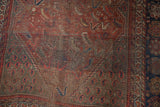 Vintage Kamseh rug field with madder root red and indigo guls, showing foundation wear.