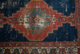 Antique Shirvan rug: detailed view of geometric medallion, arrowed patterns, and aged texture.