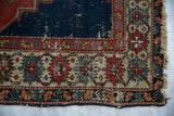 Antique Shirvan rug corner, geometric border in madder red, ivory, blue, with exposed foundation and tattered fringe.