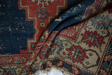 Antique Shirvan rug detail: worn geometric border, exposed foundation, and tattered fringe.