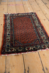 Corner detail of vintage Engelas rug: madder rust boteh field, ivory vine border, worn fringe.