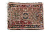 Vintage Karaja rug with a hook and latch medallion, geometric field in muted rose and navy.