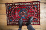 Vintage Borchalou rug showcasing concentric medallion and floral field in brick red and sapphire blue.