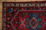 Ivory pearl motif border and sapphire blue field detail on a vintage Borchalou rug.